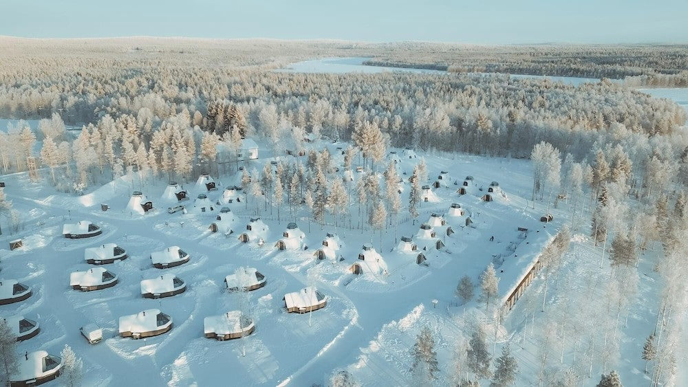 Apukka Resort cabins surrounded by deep snow and frosted forest