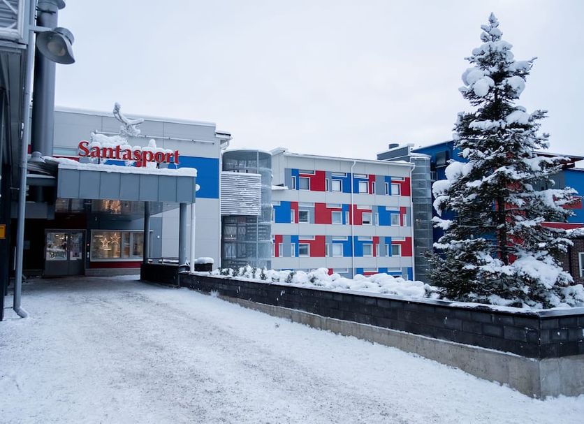 Santasport Resort entrance with snow-covered trees